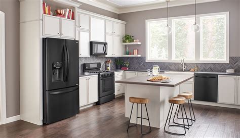 picture of black stainless steel appliance with wood cabinets|black fridge in white kitchen.